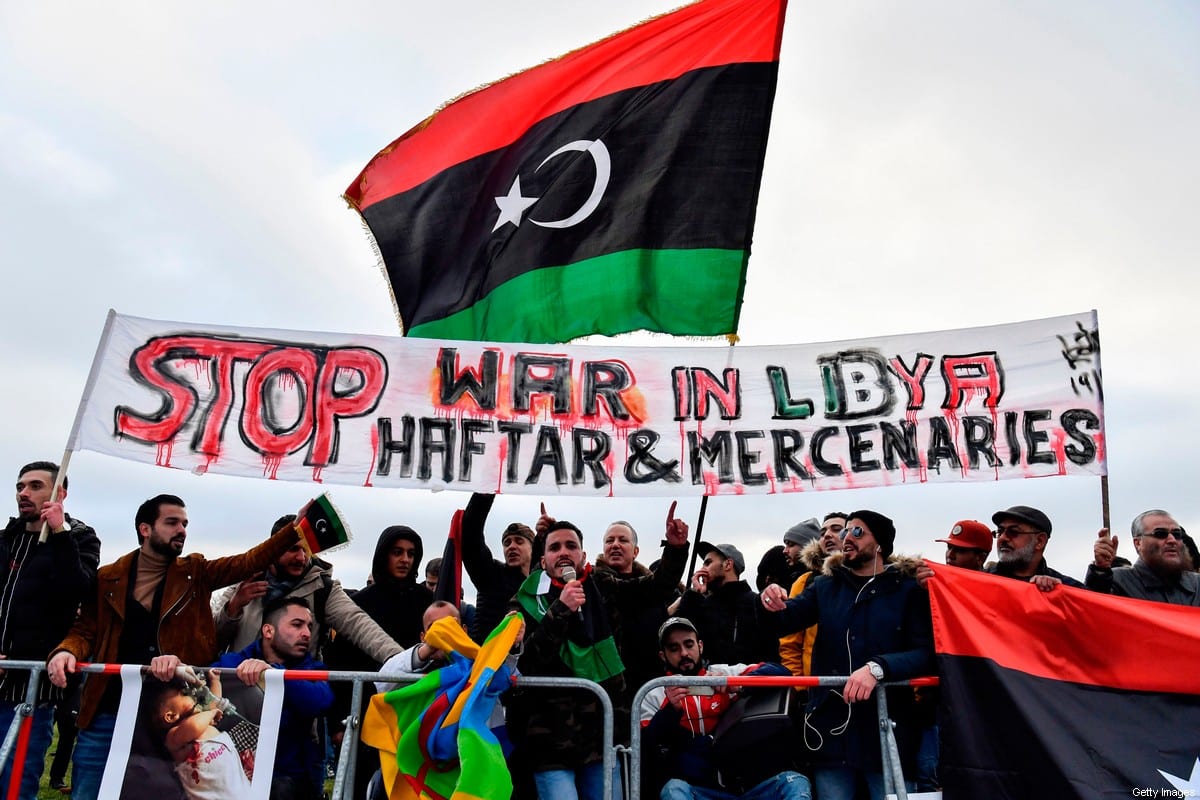 Protesters hold a banner reading 'Stop war in Libya, Haftar and mercenaries' during a protest in Berlin on 19 January 2020 [JOHN MACDOUGALL/AFP/Getty Images]