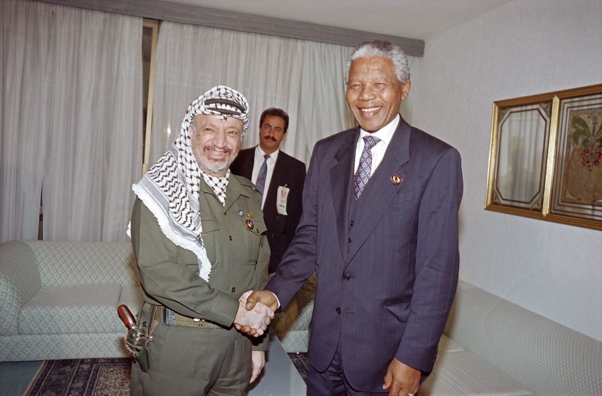 PLO Chairman Yasser Arafat (L) welcomes South African President Nelson Mandela, on June 13, 1994, at the Organization of African Unity summit (OAU), in Tunis. [FETHI BELAID/AFP via Getty Images]