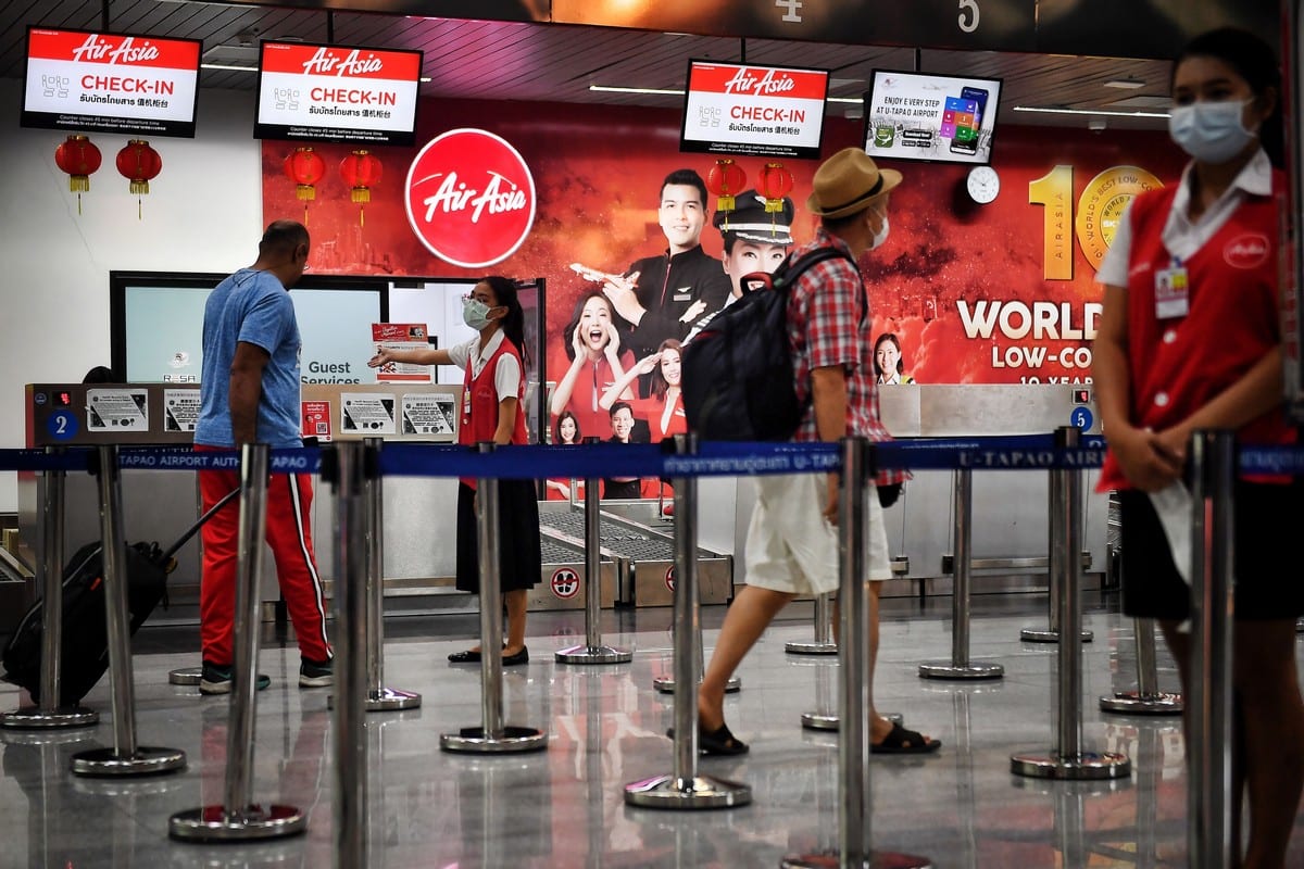 Passengers check in at U-Tapao Airport in Rayong, Thailand on 4 February 2020 [LILLIAN SUWANRUMPHA/AFP/Getty Images]
