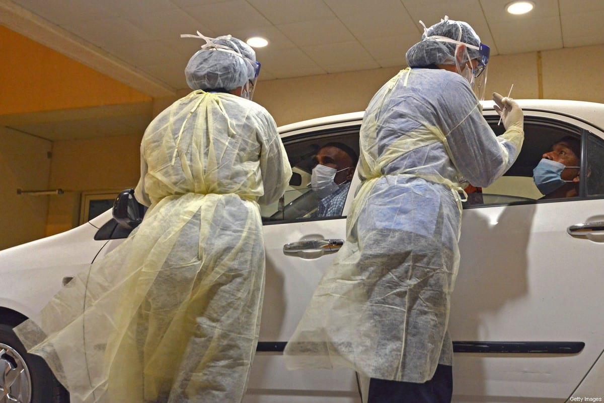 Health workers perform a nose swab test during a drive through coronavirus test campaign held in Diriyah hospital in the Saudi capital Riyadh on May 7, 2020 amid the COVID-19 pandemic [FAYEZ NURELDINE/AFP via Getty Images]