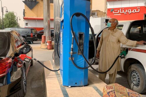 A man refills his car at a gas station in the Saudi capital Riyadh on 11 May 2020 [RANIA SANJAR/AFP/ Getty Images]