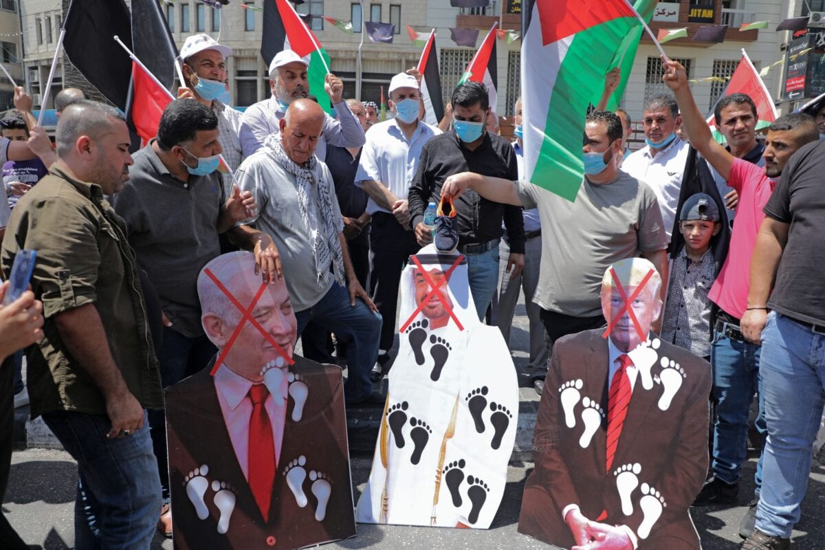 Palestinian protesters prepare to set aflame cut-outs showing the faces of (L to R) Israeli Prime Minister Benjamin Netanyahu, Abu Dhabi Crown Prince Sheikh Mohammed bin Zayed al-Nahyan, and US President Donald Trump, during a demonstration in Nablus in the occupied West Bank on August 14, 2020 against a US-brokered Israel-UAE deal to normalise relations [JAAFAR ASHTIYEH/AFP via Getty Images]