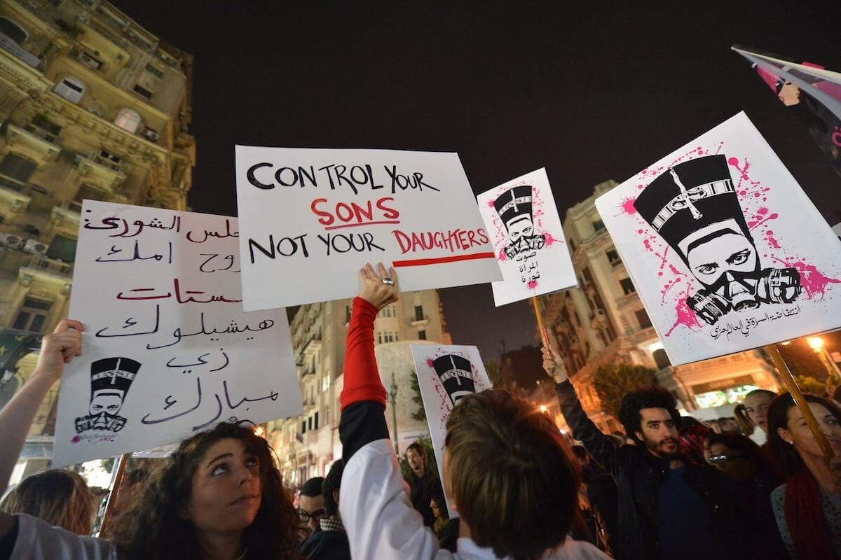 Egyptian protesters hold up placards and shout slogans during a demonstration in Cairo against sexual harassment on 12 February, 2013 [KHALED DESOUKI/AFP via Getty Images]