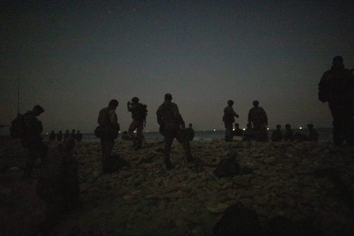 DUQM, OMAN - OCTOBER 24: Personnel from 40 Commando, Royal Marines arrive on a beach at night after moving from RFA Lyme Bay for a night time amphibious raid during exercise 'Saif Sareea 3' on October 24, 2018 in the Arabian Sea, Oman. [Dan Kitwood/Getty Images]