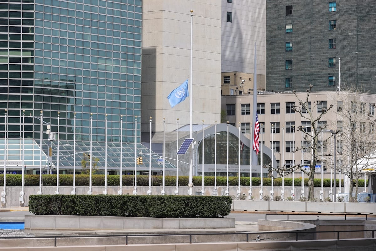 The flag of the United Nations flies at half mast at the UN Headquarters in New York City, New York, during an outbreak of the COVID-19 coronavirus, on 17 April 2020. [EuropaNewswire/Gado/Getty Images]
