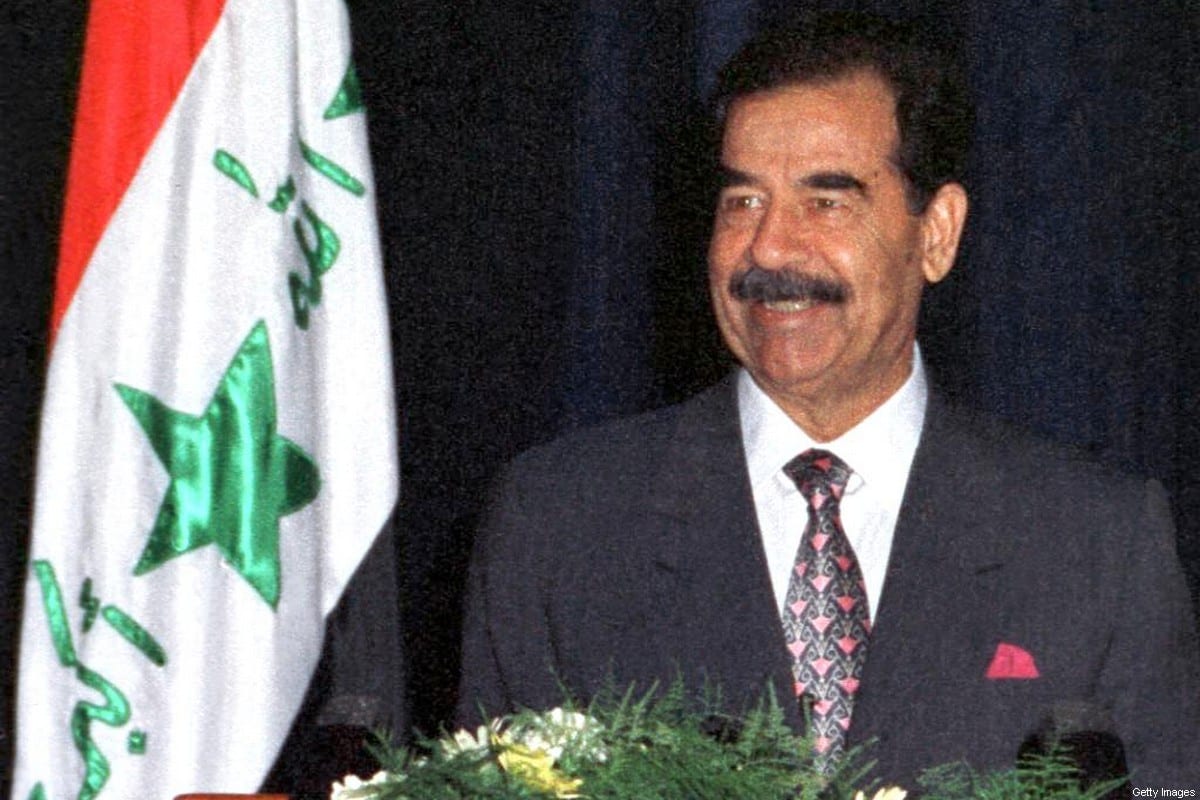 A smiling Iraqi President Saddam Hussein gives a speech 17 July 1999 in Baghdad, during celebrations marking the 31st anniversary of the Baath party revolution in Iraq [AFP via Getty Images]