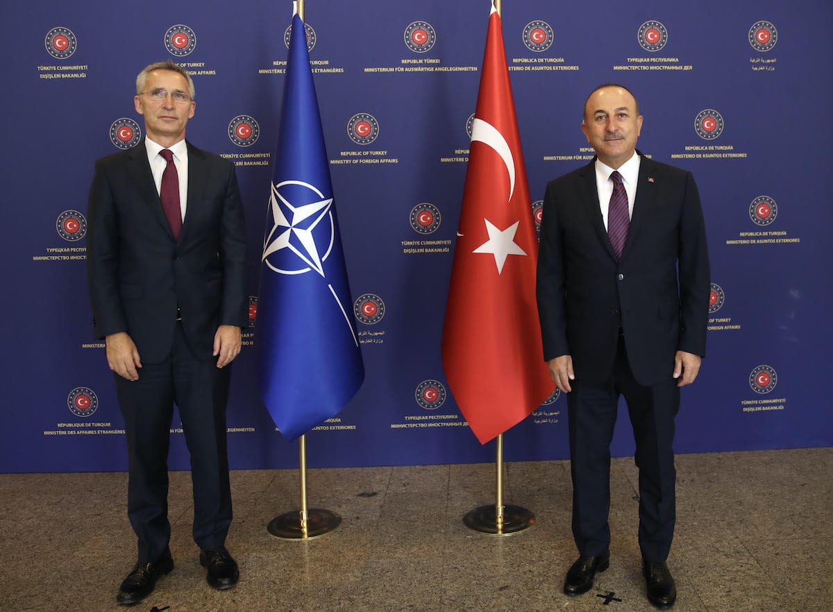 Turkish Foreign Minister Mevlut Cavusoglu (R) poses for a photo with NATO Secretary General Jens Stoltenberg (L) before their meeting at the Foreign Ministry building in Ankara, Turkey [Fatih Aktaş - Anadolu Agency]