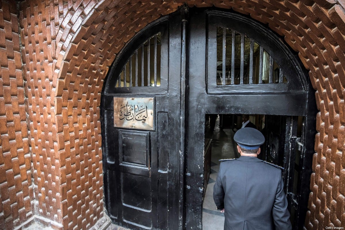 Egyptian police officer entering the Tora prison in the Egyptian capital Cairo, on February 11, 2020 [KHALED DESOUKI/AFP via Getty Images]