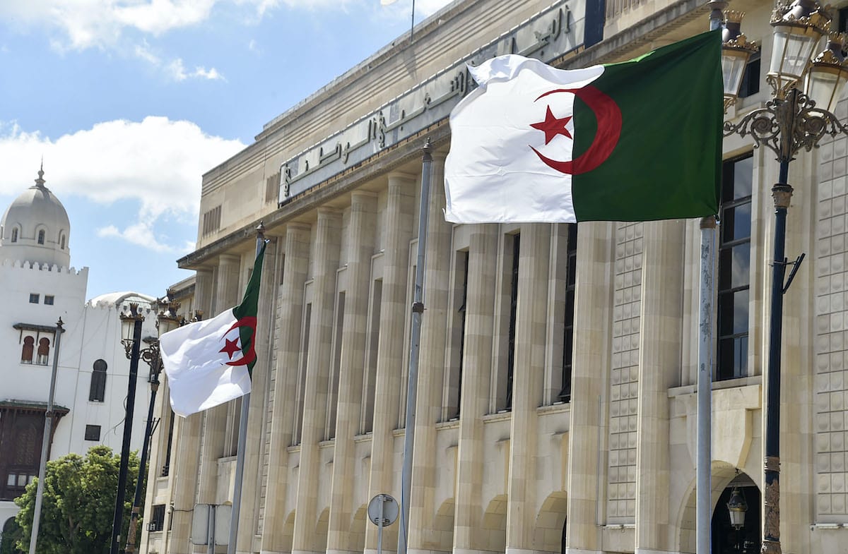 Algerian flags flutter in front of the People's National Assembly (parliament) building in the capital Algiers, on 10 September 2020. [RYAD KRAMDI/AFP via Getty Images]