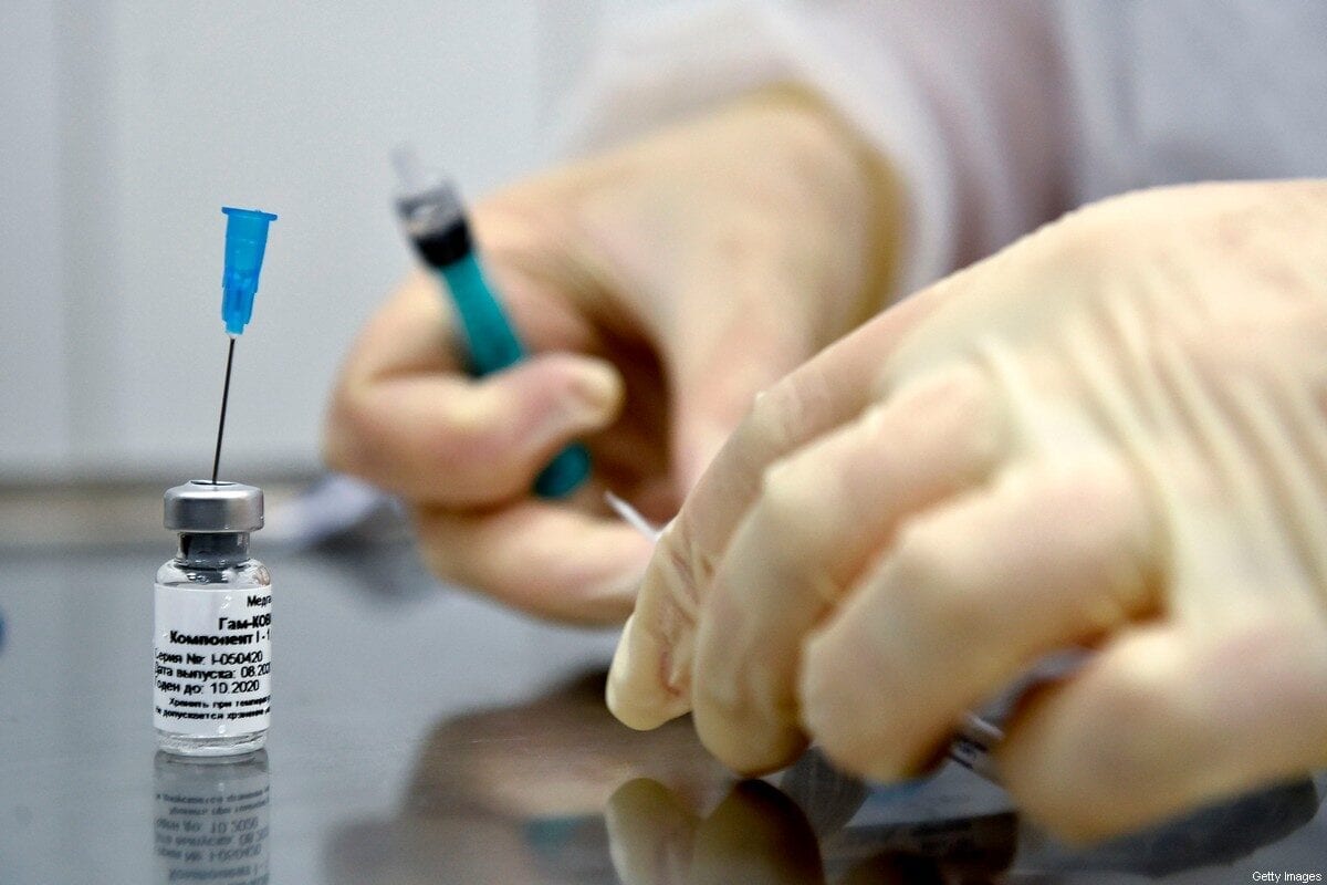 A nurse prepares to inoculate volunteer Ilya Dubrovin, 36, with Russia's new coronavirus vaccine in a post-registration trials at a clinic in Moscow on September 10, 2020. - Russia announced last month that its vaccine, named "Sputnik V" after the Soviet-era satellite that was the first launched into space in 1957, had already received approval. The vaccine was developed by the Gamaleya research institute in Moscow in coordination with the Russian defence ministry. (Photo by Natalia KOLESNIKOVA / AFP) (Photo by NATALIA KOLESNIKOVA/AFP via Getty Images)