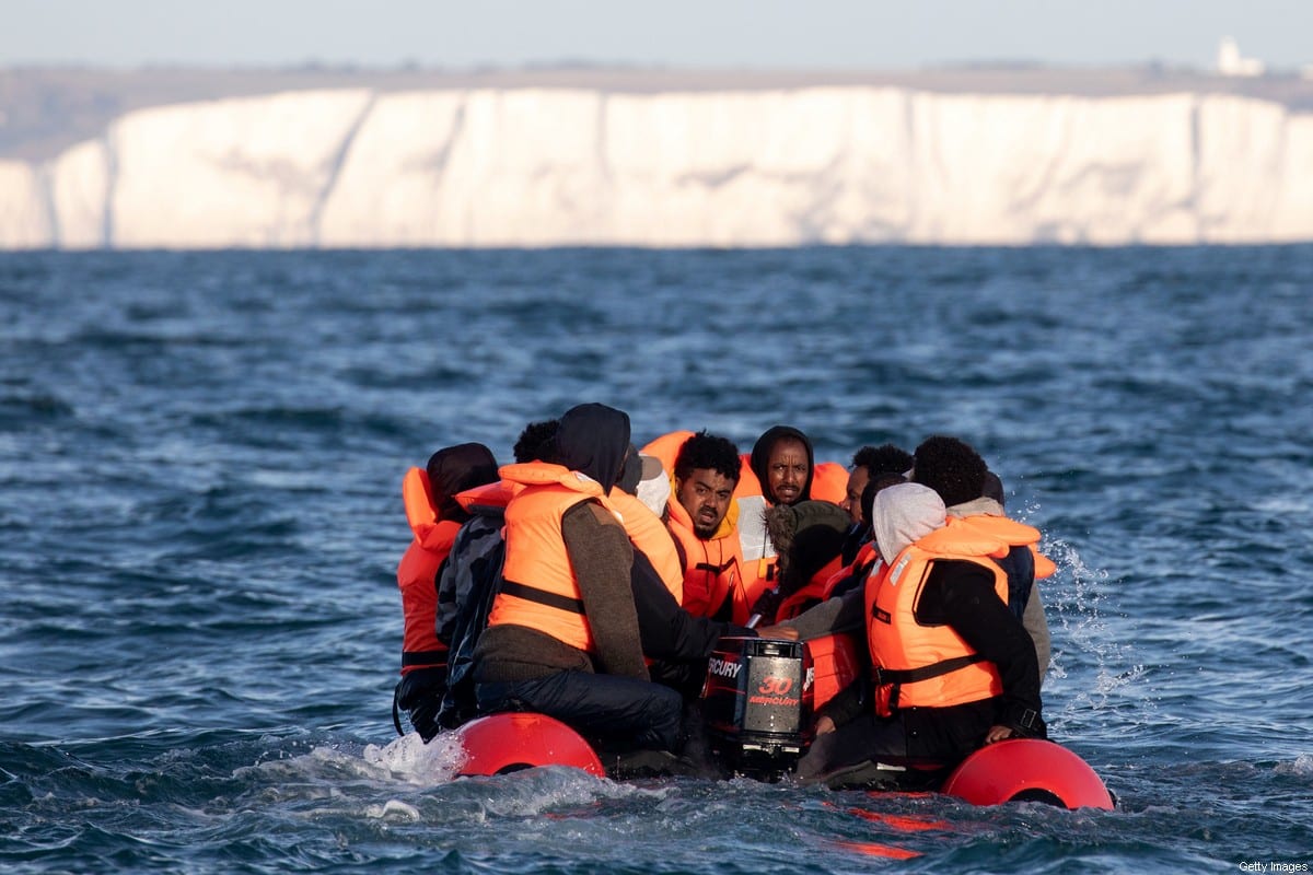 AT SEA, UNITED KINGDOM - SEPTEMBER 07: Migrants packed tightly onto a small inflatable boat attempt to cross the English Channel near the Dover Strait, the world's busiest shipping lane, on September 07, 2020 off the coast of Dover, England. Last Wednesday, more than 400 migrants made the journey from France to England by sea, either intercepted by UK border force or arriving on shore in their small boats. (Photo by Luke Dray/Getty Images)