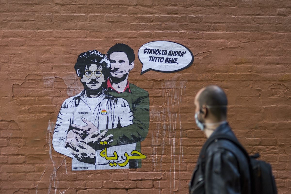 A person walks by the mural created by the artist Laika a few metres from the Rectorate of the University of Bologna, to ask for Patrick Zaki's release a few days before the trial on October 05, 2020 in Bologna, Italy. [Michele Lapini/Getty Images]