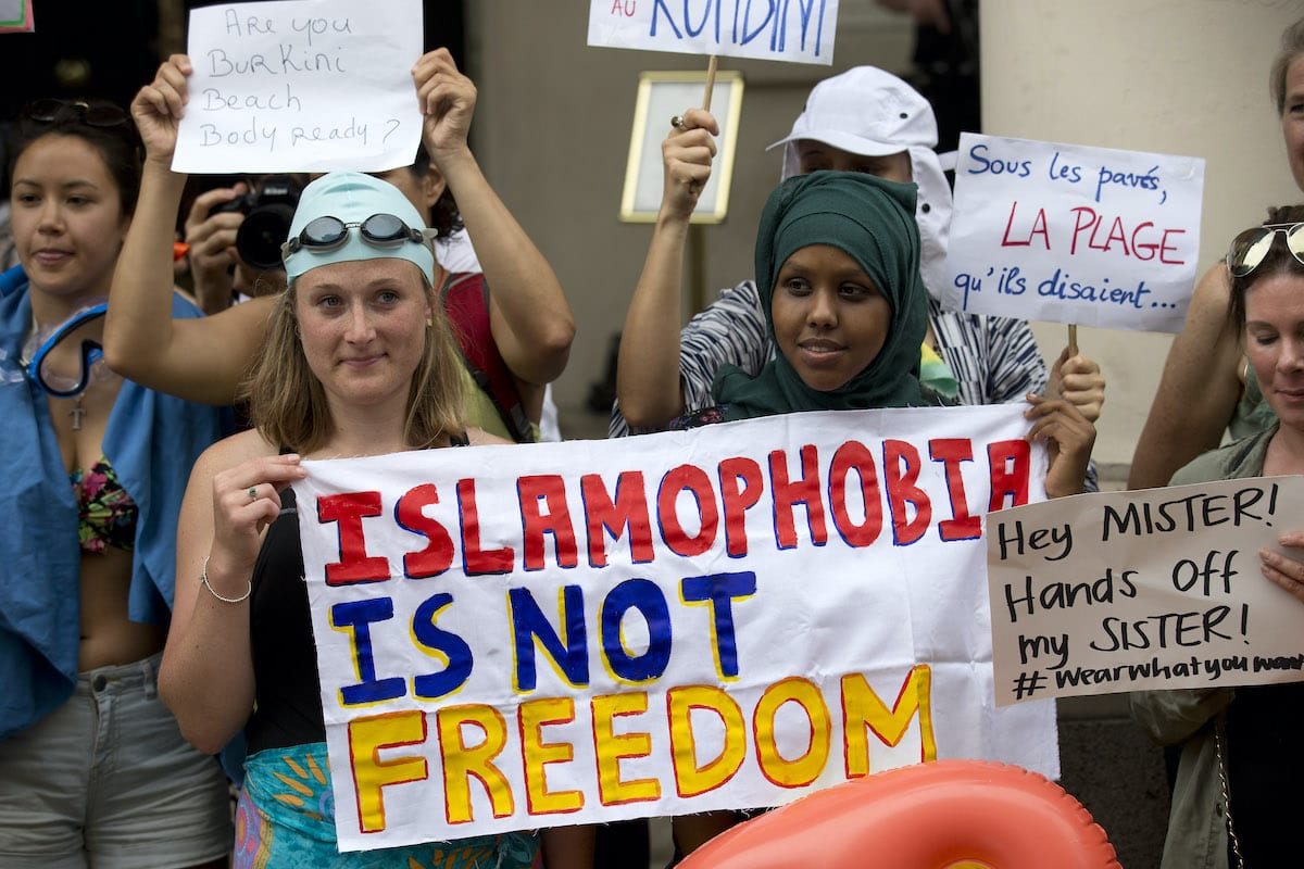 Protesters holds a sign which reads " Islamophobia is not freedom" outside the French Embassy in London on August 25, 2016 [JUSTIN TALLIS/AFP via Getty Images]