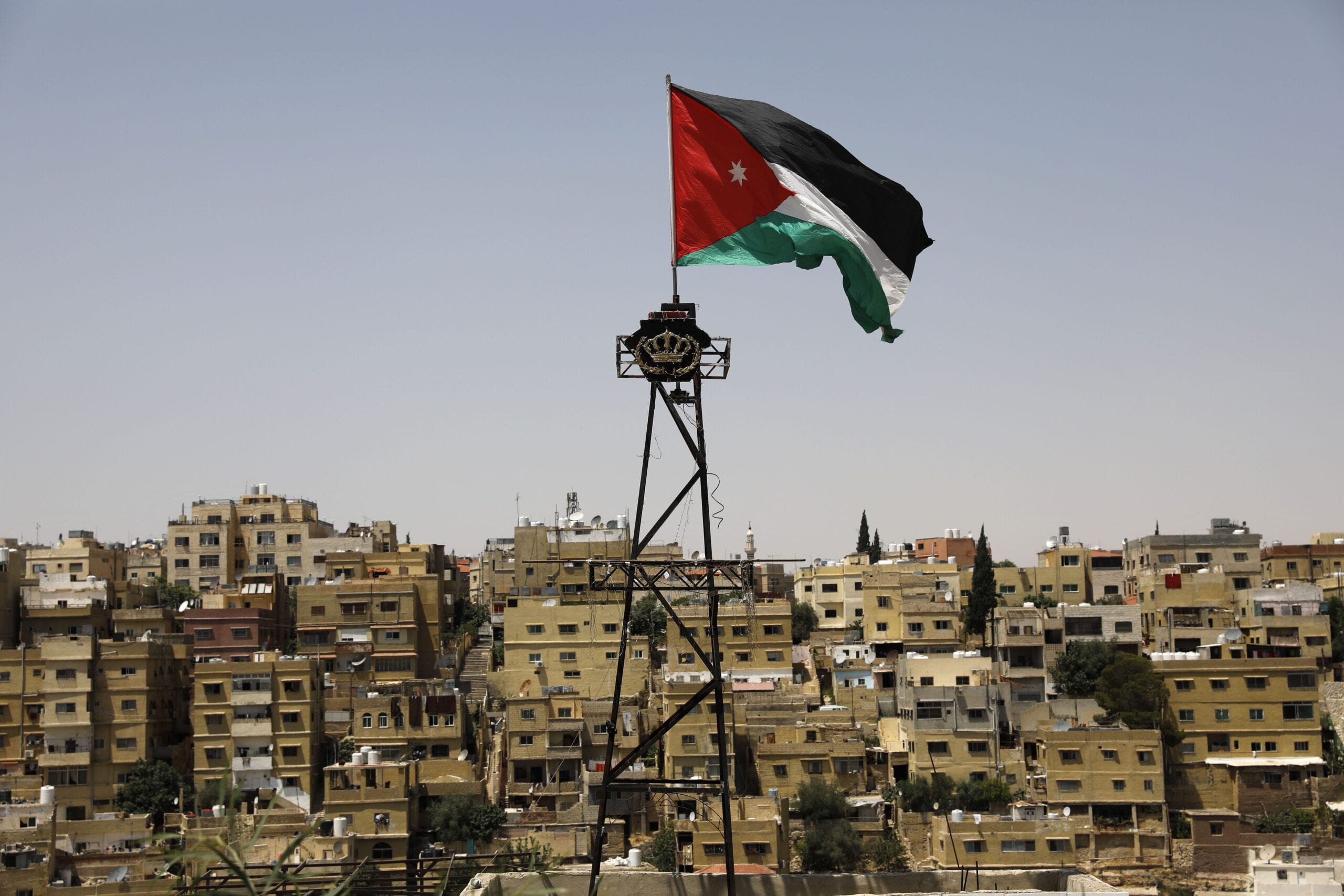A general view taken from Jabal al-Qala district shows a Jordanian flag fluttering above the Jordanian capital Amman [AHMAD GHARABLI/AFP via Getty Images]