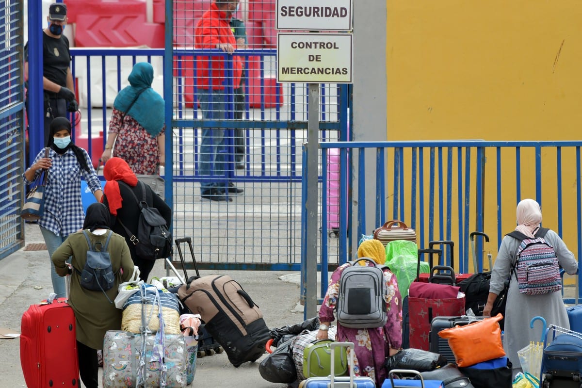 Moroccan nationals, stranded in Spain, go through customs prior to crossing the Spanish-Moroccan border in the Spanish enclave of Ceuta on 30 September 2020 [ANTONIO SEMPERE/AFP/Getty Images]