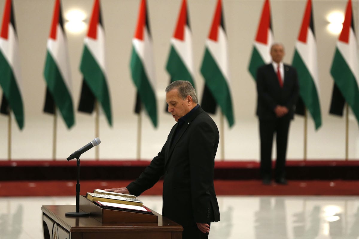 Nabil Abu Rudeineh is sworn in as a deputy Prime Minister and Minister of Information in the new Palestinian government, in the Israeli-occupied West Bank town of Ramallah, on 13 April 2019. [ABBAS MOMANI/AFP via Getty Images]