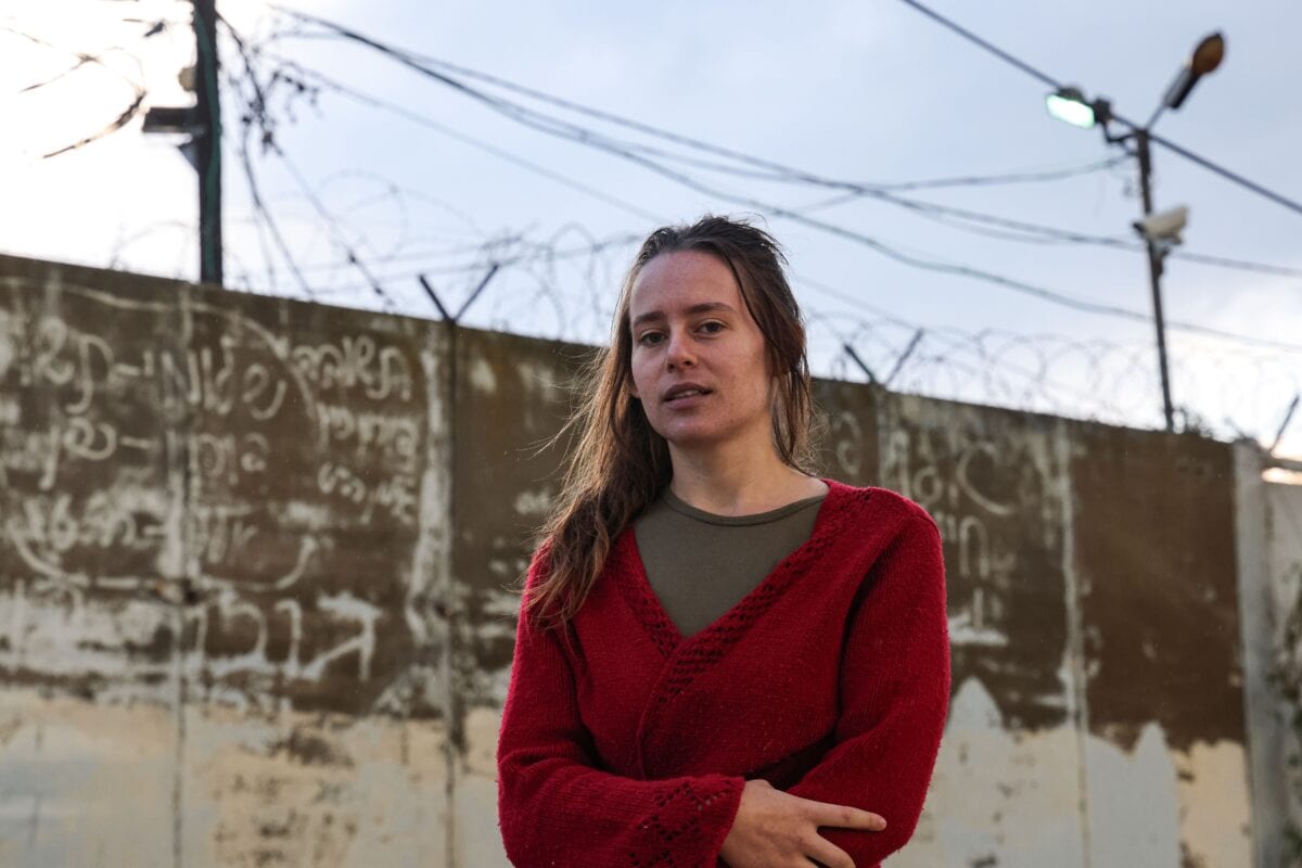 Hallel Rabin, a 19-year-old Israeli conscientious objector, poses for a picture outside the "number six" military prison near Atlit in northern Israel on November 20, 2020, upon release from jail for refusing to serve in the Israeli army. - Army service is compulsory for most Israeli citizens and while many seek exemptions on various grounds -- some arguably less than truthful -- Rabin's case is unusual in that she openly declared herself to be a pacifist and served prison time. Hallel had served a total of 56 days since August at the grim military prison "number six", and was facing up to 80 more in detention. But after grilling her at four hearings, an army board finally accepted that her pacifism was sincere and not driven by "political considerations," which would have landed her more prison time. (Photo by Emmanuel DUNAND / AFP) (Photo by EMMANUEL DUNAND/AFP via Getty Images)