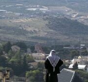 A Palestinian man looks towards the Israeli settlement of Shavei Shomron built next to the Palestinian village of Naqoura, west of Nablus in the occupied West Bank, on 23 November 2020. [JAAFAR ASHTIYEH/AFP via Getty Images]