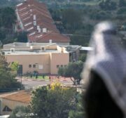 A Palestinian man looks towards the illegal Israeli settlement built next to Nablus in the occupied West Bank, on 23 November 2020 [JAAFAR ASHTIYEH/AFP/Getty Images]