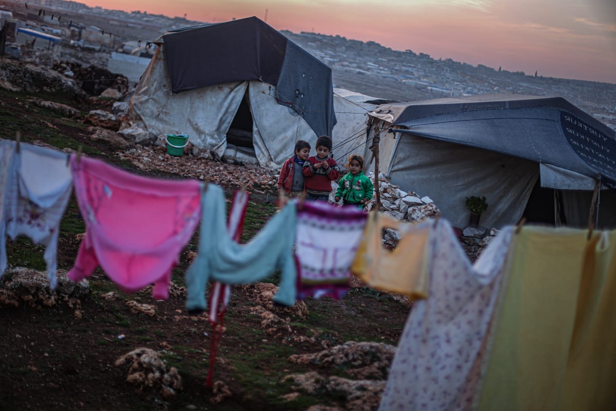 Civilians who fled from the attacks of the Assad regime are seen in a refugee camp in Idlib, Syria on 5 December 2020 [Muhammed Said/Anadolu Agency]