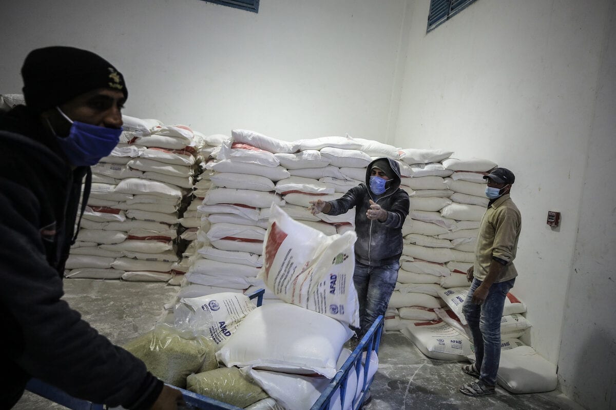 JABALIA, GAZA - DECEMBER 17: Workers of United Nations Palestine Refugee Agency (UNRWA) package humanitarian aid coming from different countries for Palestinian refugees to distribute them in Jabalia, Gaza on December 17, 2020. ( Ali Jadallah - Anadolu Agency )