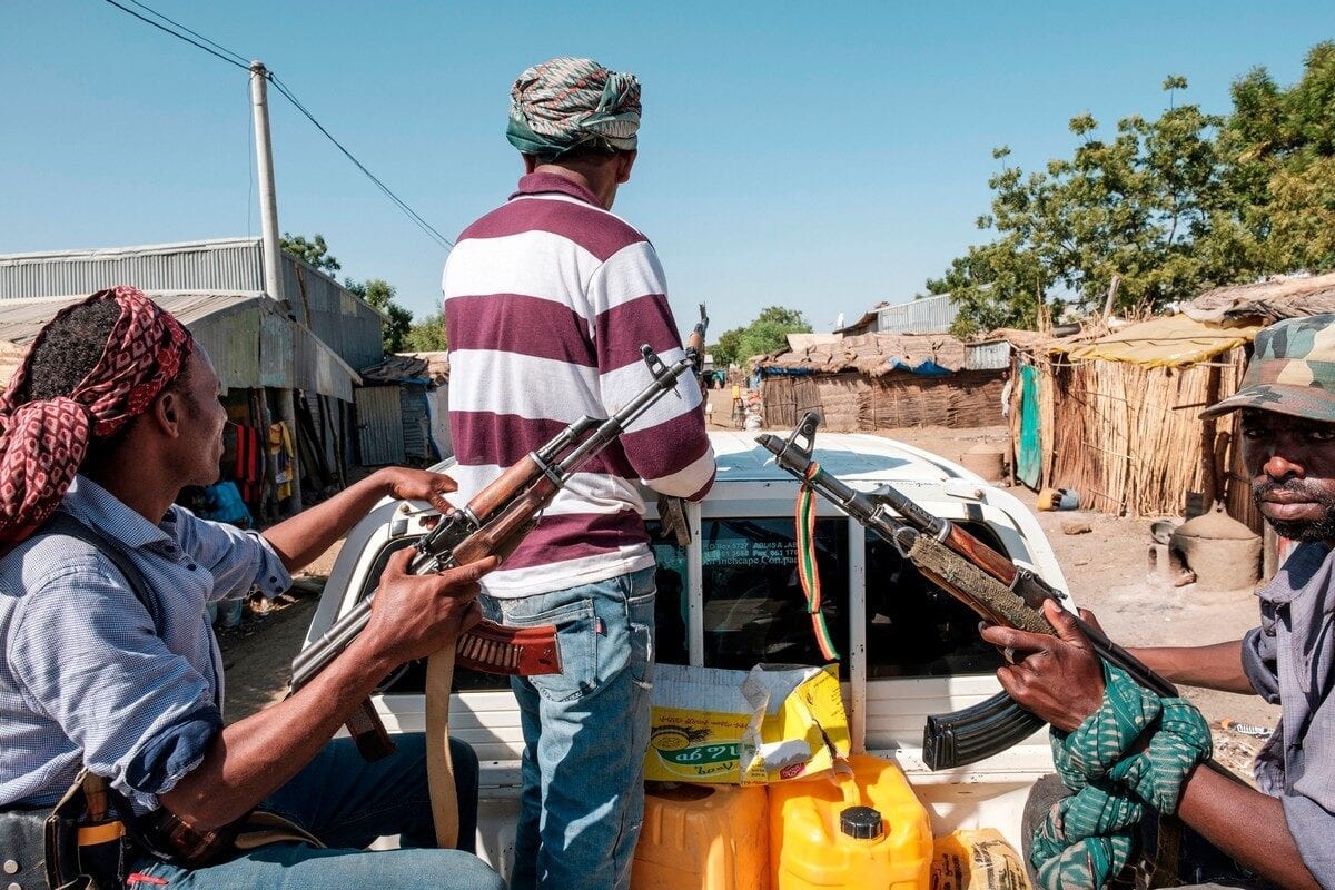 Ethiopian militias ride in the back of a pick up truck in Ethiopia, on 21 November 2020 [EDUARDO SOTERAS/AFP/Getty Images]