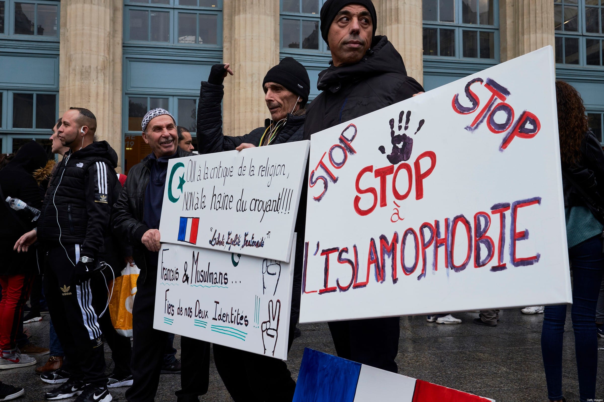 Muslim men hold banners against islamophobia on November 10, 2019 [Pierre Crom/Getty Images]