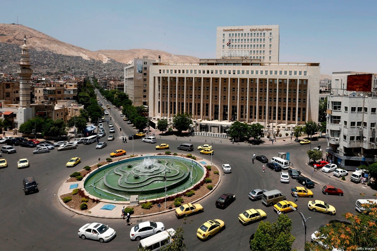 Vehicles drive along the roundabout past the Central bank of Syria in the capital Damascus' Sabaa Bahrat Square on June 17, 2020 [LOUAI BESHARA / AFP via Getty Images]