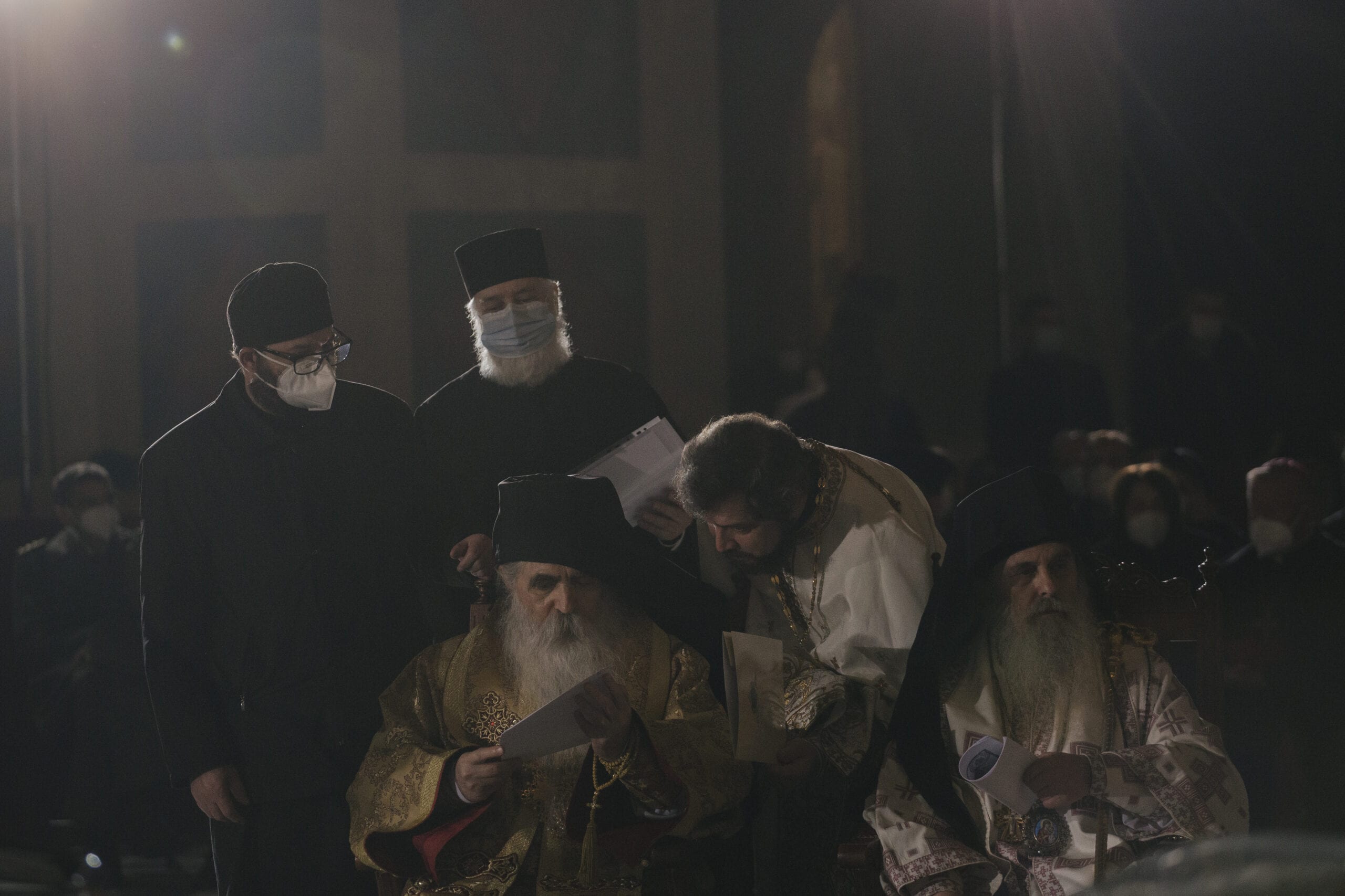 Priests stand by the casket of Patriarch Irinej at the St. Sava Temple before the funeral procession at the St. Sava Temple on November 22, 2020 in BELGRADE, Serbia [Vladimir Zivojinovic/Getty Images]