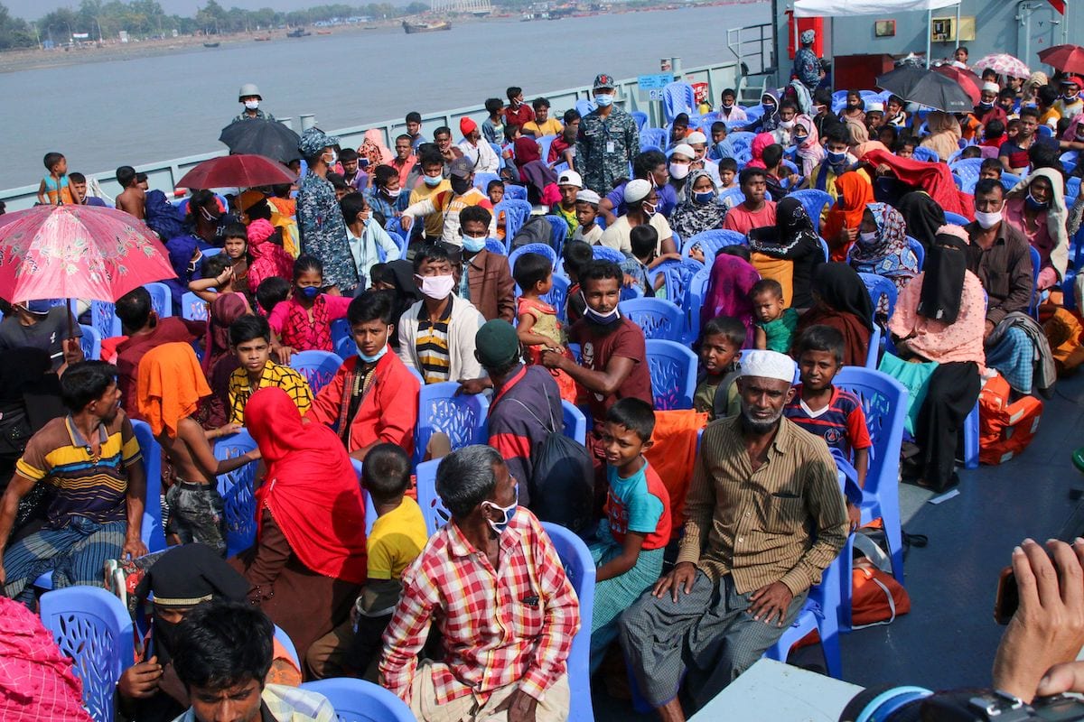 Rohingya refugees board a Bangladesh Navy ship to be transported to the island of Bhashan Char in Chittagong on 4 December 2020. [AFP via Getty Images]