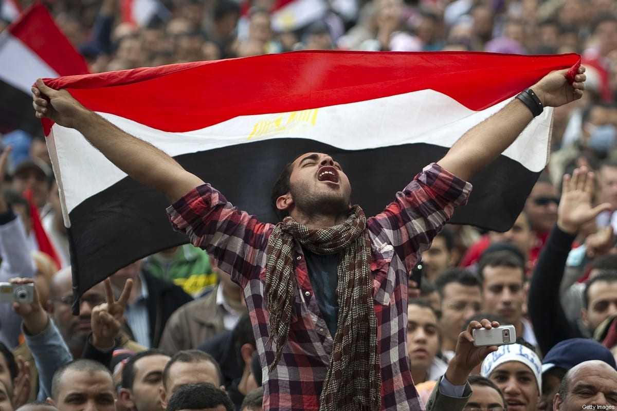 An Egyptian anti-goverment holds his national flag as he shouts slogans against President Hosni Mubarak at Cairo's Tahrir Square on 10 February 2011 [PEDRO UGARTE/AFP/Getty Images]