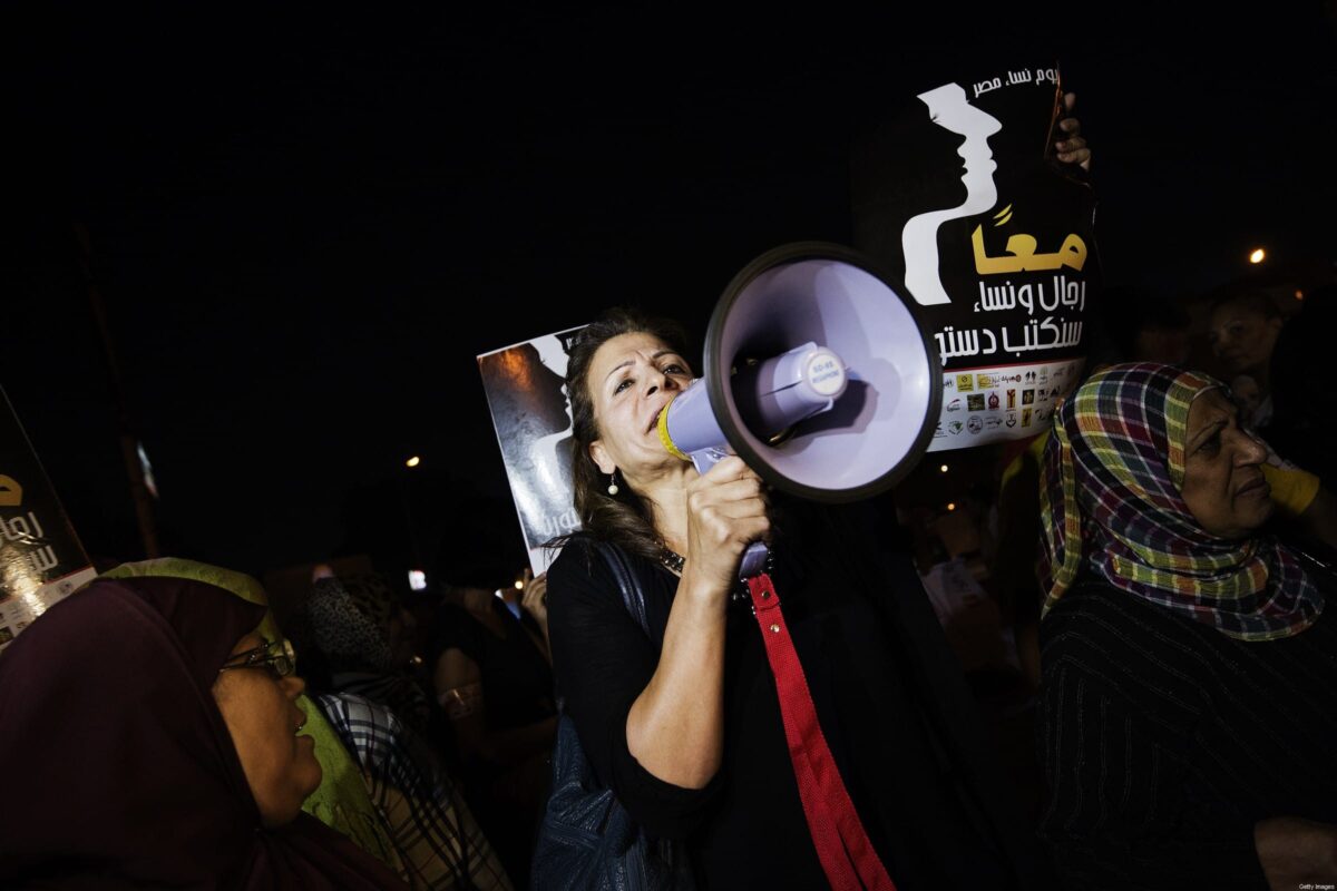 Egyptian women and activists hold slogans which read in Arabic 'Together men and women, we will write our constitution' as they demonstrate in front of the presidential palace in Cairo on 4 October 2012 [GIANLUIGI GUERCIA/AFP/Getty Images]