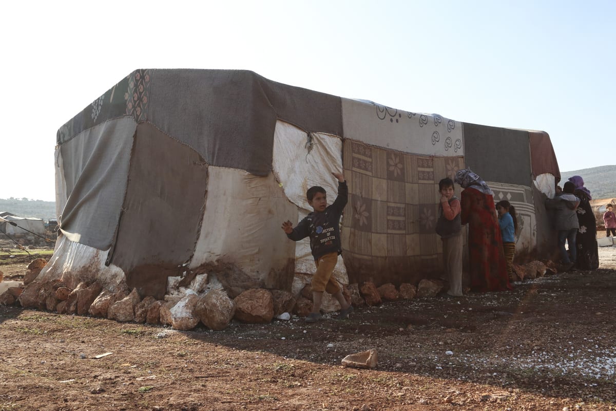 IDLIB, SYRIA - DECEMBER 29: Syrian women fix tents damaged due to winter conditions with needle and thread to strengthen them against cold and rain at a refugee camp in Idlib, Syria on December 29, 2020. ( Muhammed Abdullah - Anadolu Agency )
