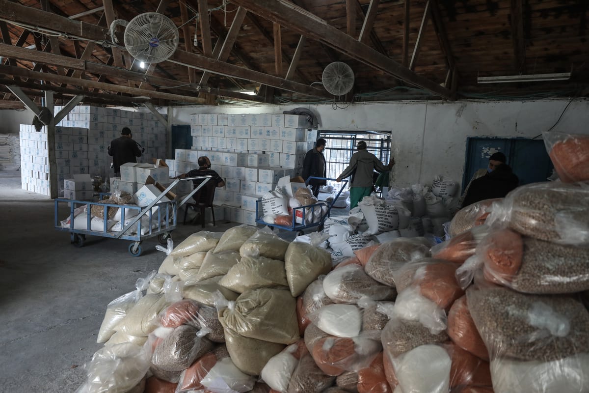 GAZA CITY, GAZA - JANUARY 14: Workers of United Nations Palestine Refugee Agency (UNRWA) prepare aids distribute to Palestinian refugees in Al-Shati Camp in Gaza City, Gaza on January 14, 2020. ( Ali Jadallah - Anadolu Agency )