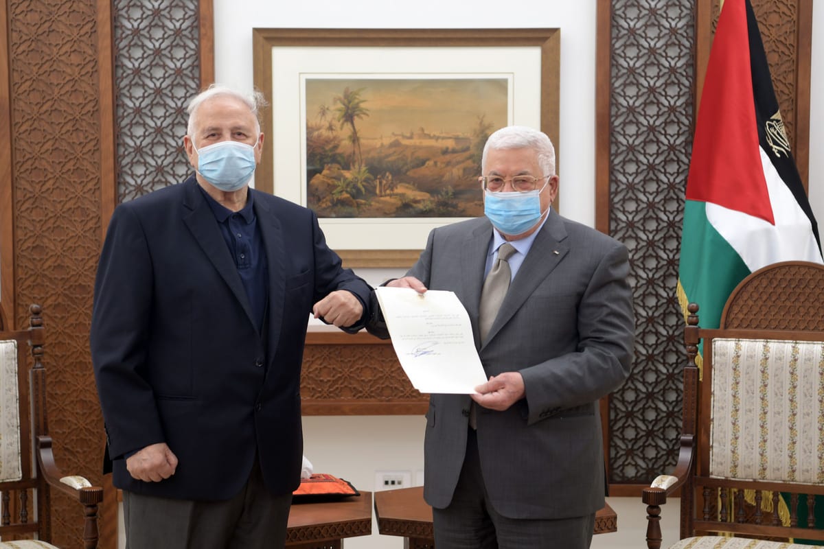 Palestinian President, Mahmoud Abbas (R) signs the decree for holding parliamentary, presidential elections on May 22, July 31, respectively, after meeting with Chairman of the Palestinian Central Elections Commission Hanna Nasser (L) in Ramallah, West Bank on January 15, 2021. [Palestinian Presidency / Handout - Anadolu Agency]