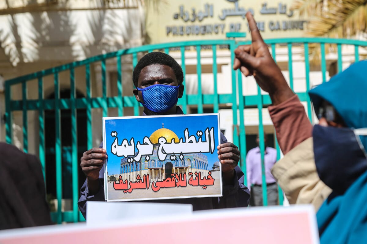 Sudanese people rally against their country's recent signing of a deal on normalising relations with Israel, outside the cabinet offices in the capital Khartoum, Sudan on January 17, 2021 [Mahmoud Hjaj/Anadolu Agency]