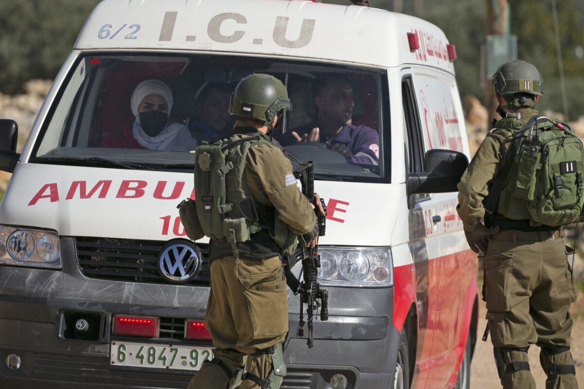 Israeli soldiers stop an ambulance amid clashes with Palestinian protesters following a demonstration against the expansion of settlements in the town of Salfit, in the Israeli-occupied West Bank, on December 4, 2020. (Photo by JAAFAR ASHTIYEH / AFP) (Photo by JAAFAR ASHTIYEH/AFP via Getty Images)