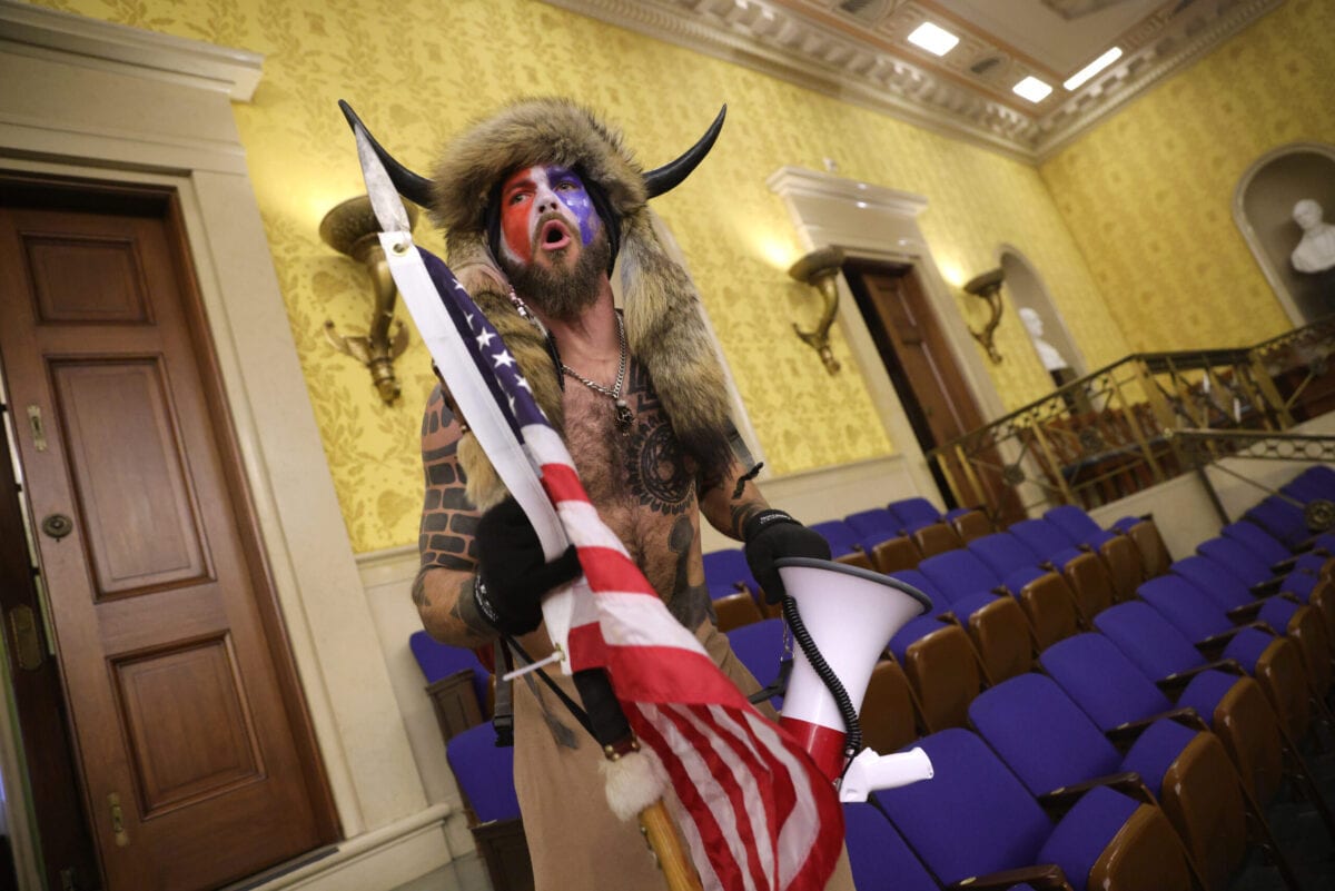 A protester screams "Freedom" inside the Senate chamber after the U.S. Capitol was breached by a mob during a joint session of Congress on January 06, 2021 in Washington, DC [Win McNamee/Getty Images]