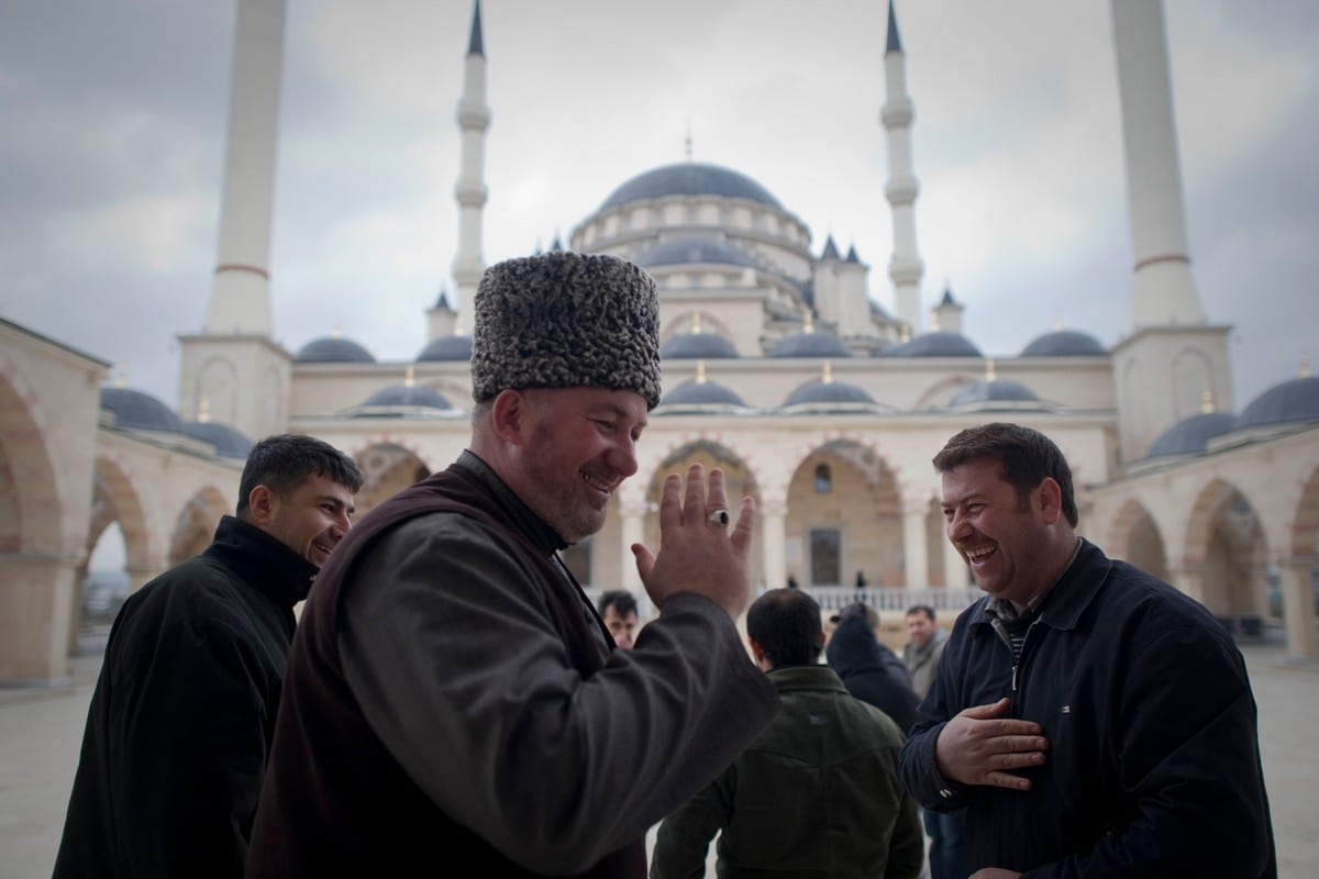 Men smile near Grozny's main mosque in Russia on 7 March 2011 [DMITRY KOSTYUKOV/AFP/Getty Images]