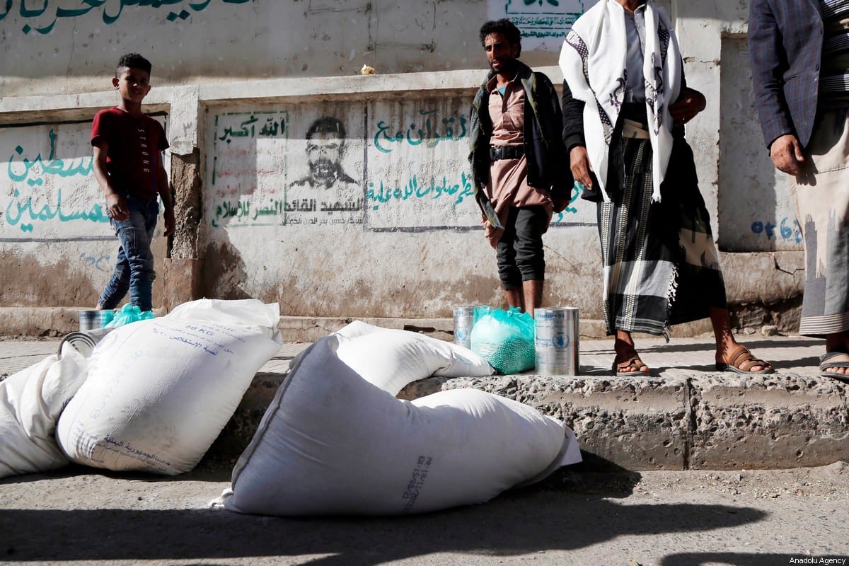 Yemenis receive food aid distributed by United Nations World Food Programme (WFP) in Sanaa, Yemen on 26 January 2021 [Mohammed Hamoud/Anadolu Agency]