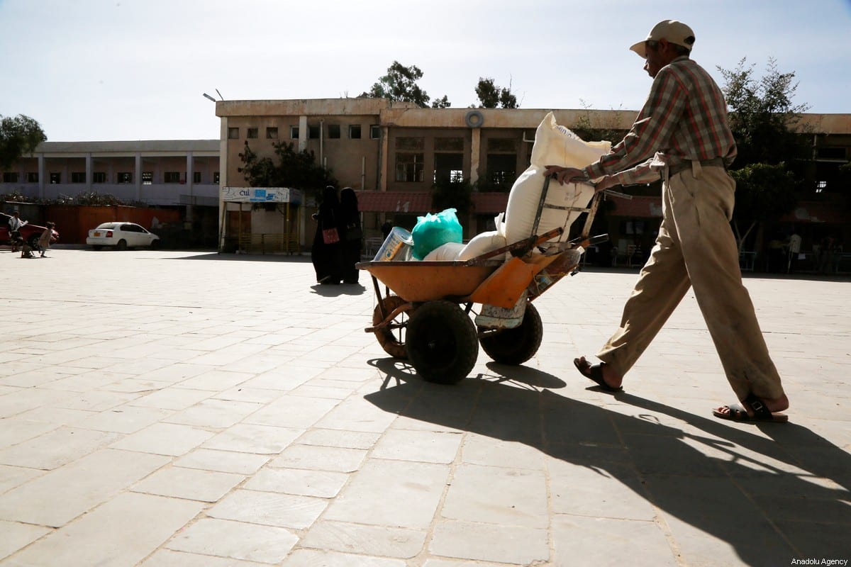 Yemenis receive food aid distributed by United Nations World Food Programme (WFP) in Sanaa, Yemen on January 26, 2021 [Mohammed Hamoud / Anadolu Agency]