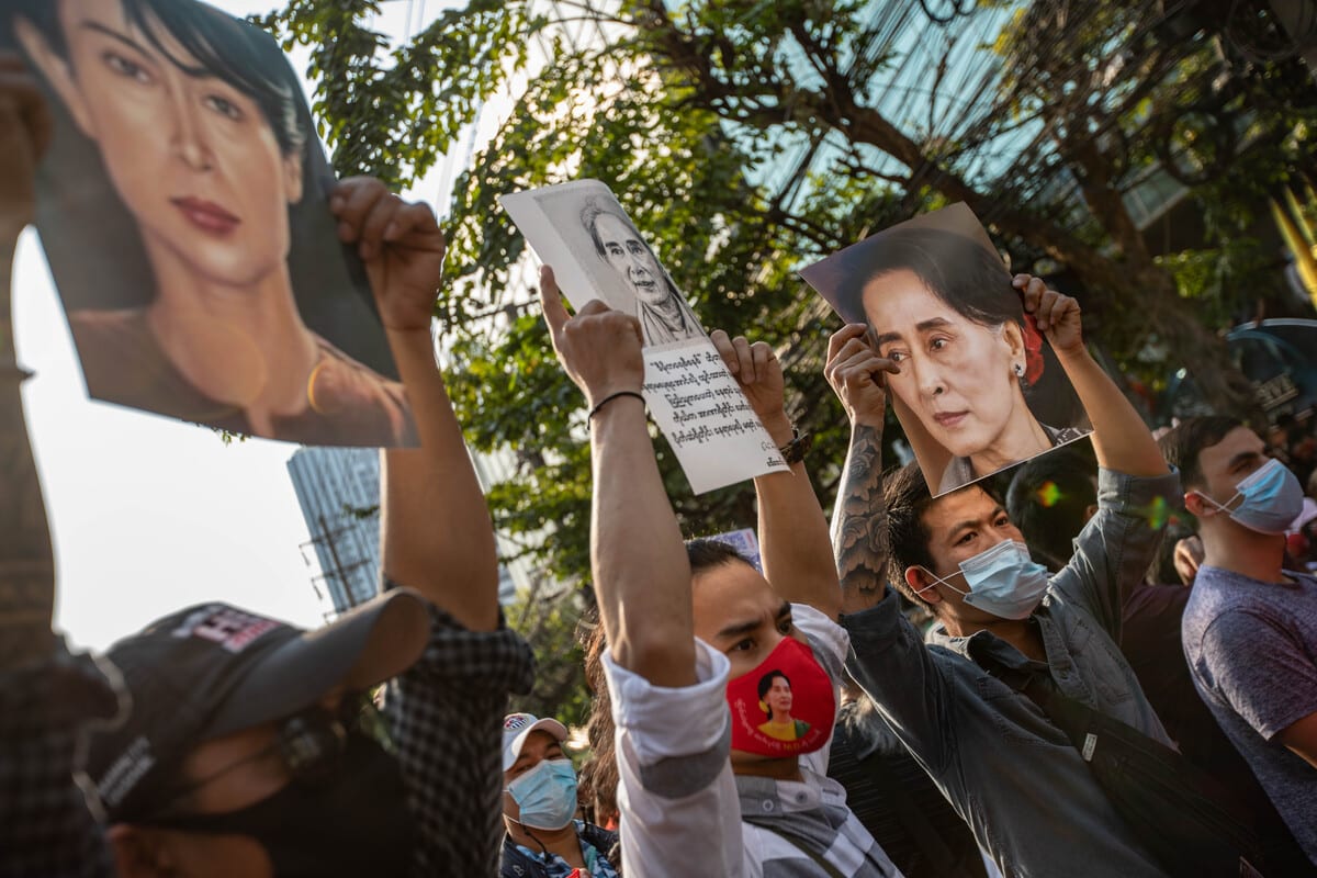 Demonstrators hold portraits of Aung San Suu Kyi during a protest outside the Embassy of Myanmar in Bangkok, Thailand on 1 February 2021. [Guillaume Payen - Anadolu Agency]
