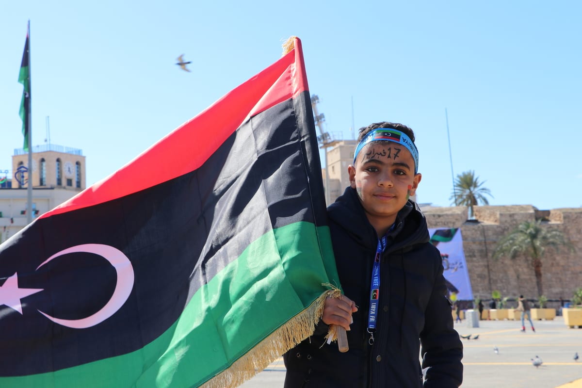 Libyans holding flags celebrate the 10th anniversary of Libyans’ February 17 Revolution which put an end to 42 years of Muammar Gaddafi dictatorship in 2011 at Martyrs' Square in Tripoli, Libya on 16 February 2021. [Mücahit Aydemir - Anadolu Agency]