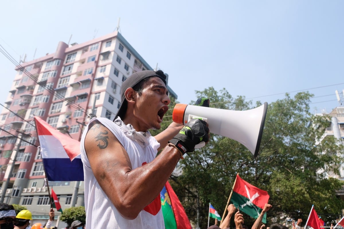 YANGON, MYANMAR - FEBRUARY 27: Protesters shout slogans behind the barricade during a protest against the military coup in Yangon, Myanmar on February 27, 2021. ( Stringer - Anadolu Agency )