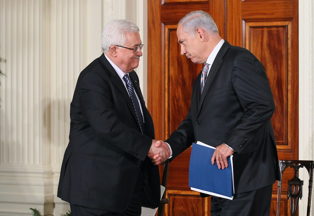 Palestinian Authority President Mahmoud Abbas (L) shakes hands with Israeli Prime Minister Benjamin Netanyahu (R) during an East Room statement at the White House on the first day of the Middle East peace talks September 1, 2010 in Washington, DC [Alex Wong/Getty Images]
