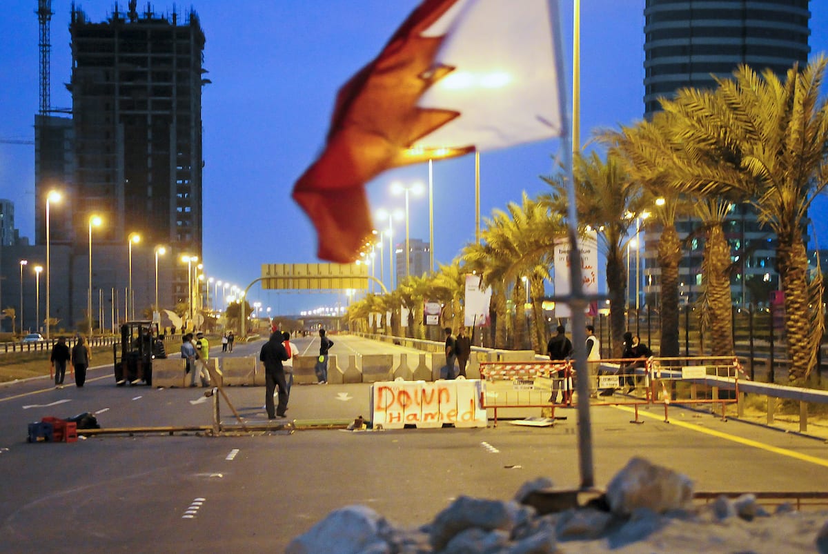 Bahraini anti-government protesters place concrete roadblocks on the highway leading to Pearl Square in Manama on 14 March 2011. [JAMES LAWLER DUGGAN/AFP via Getty Images]