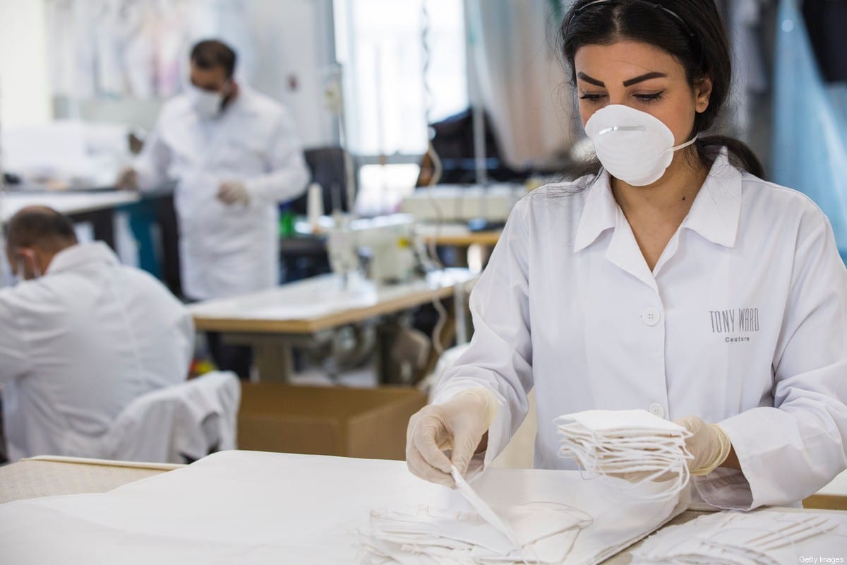 Workers wear medical face masks during the COVID-19 pandemic in in Beirut, Lebanon on 26 March 2020 [Daniel Carde/Getty Images]