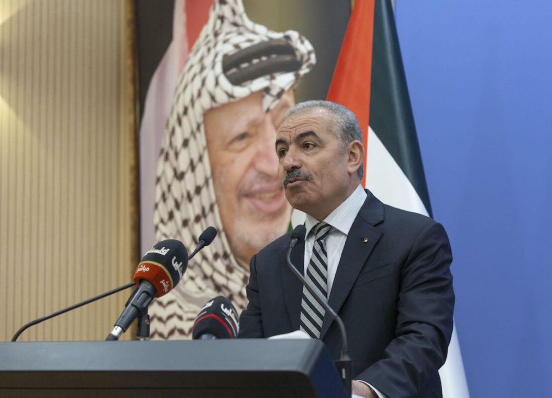 Palestinian Prime Minister Muhammad Shtayyeh chairs the weekly cabinet meeting at his office near a poster of late Palestinian leader Yasser Arafat in the West Bank city of Ramallah, on 17 August 2020 [NASSER NASSER/POOL/AFP via Getty Images]