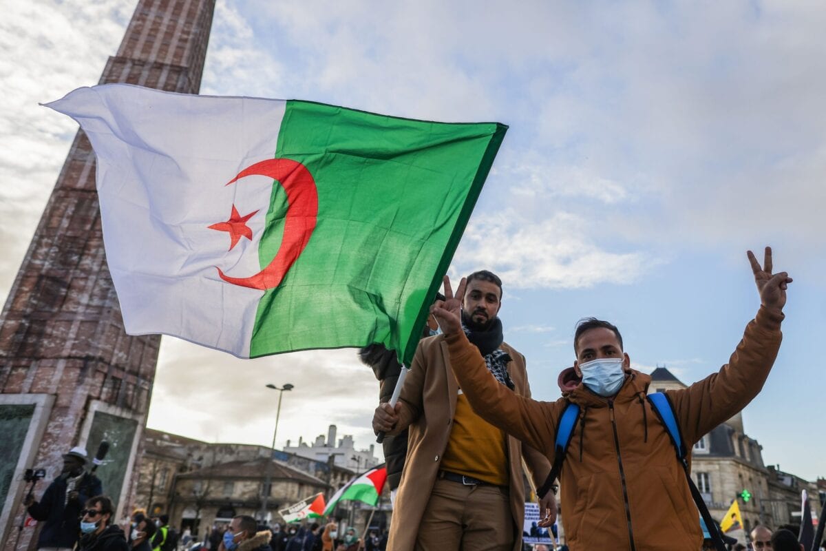 Protestors hold an Algerian flag during a demonstration, in Bordeaux, southwestern France on December 12, 2020 [THIBAUD MORITZ/AFP via Getty Images]