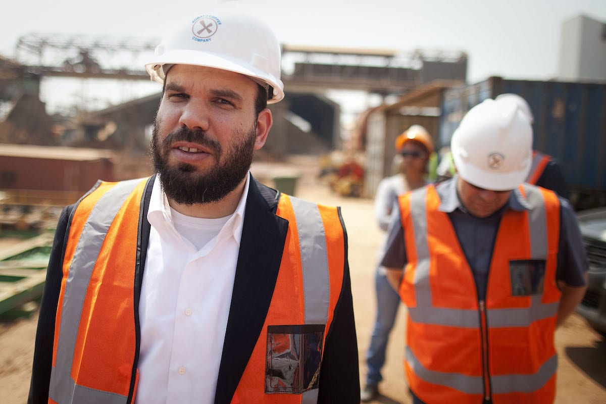 Dan Gertler, Israeli mining investor, left, takes a tour of the Katanga Mining Ltd. copper-cobalt mine complex, partly operated by the Kamoto Copper Co., with Shimon Cohen, his communications advisor, right, in Kolwezi, Democratic Republic of Congo, on 1 Wednesday, Aug. 2012. [Simon Dawson/Bloomberg via Getty Images]